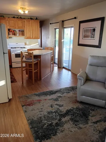 a view of kitchen with furniture and wooden floor