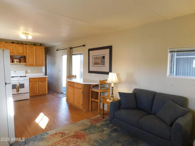 a living room with furniture and a kitchen view