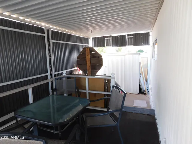 a view of a kitchen with refrigerator and wooden floor