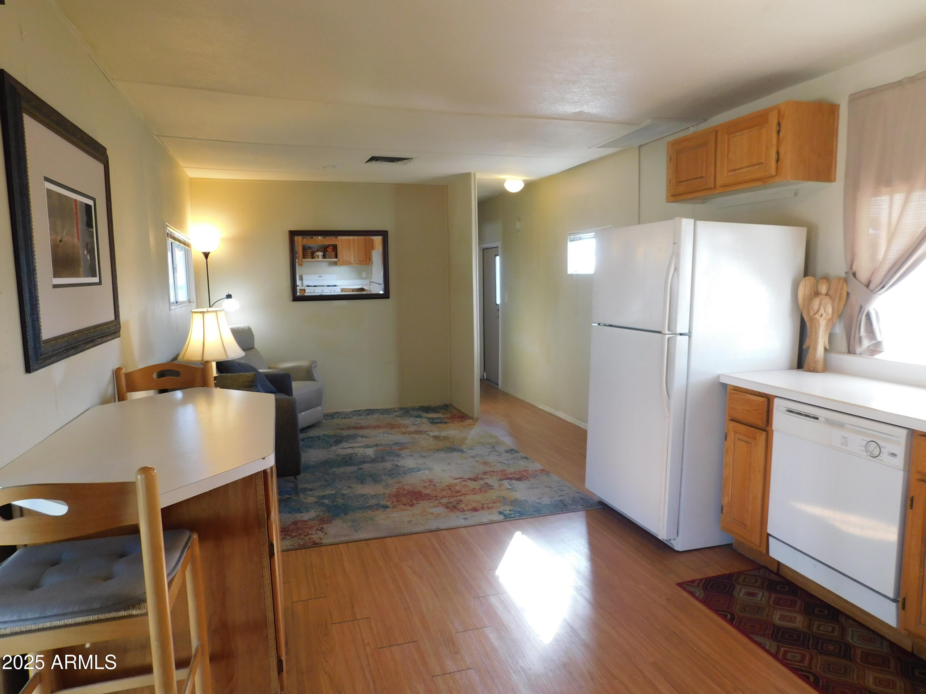 15802 South Gilbert Road, Unit 58 Chandler, AZ 85225 - Photo 6 of 21 a view of a kitchen with refrigerator and wooden floor