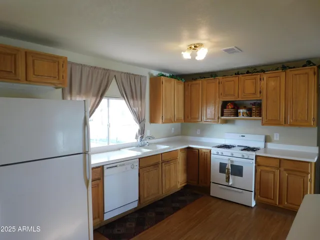 a living room with furniture and a kitchen view