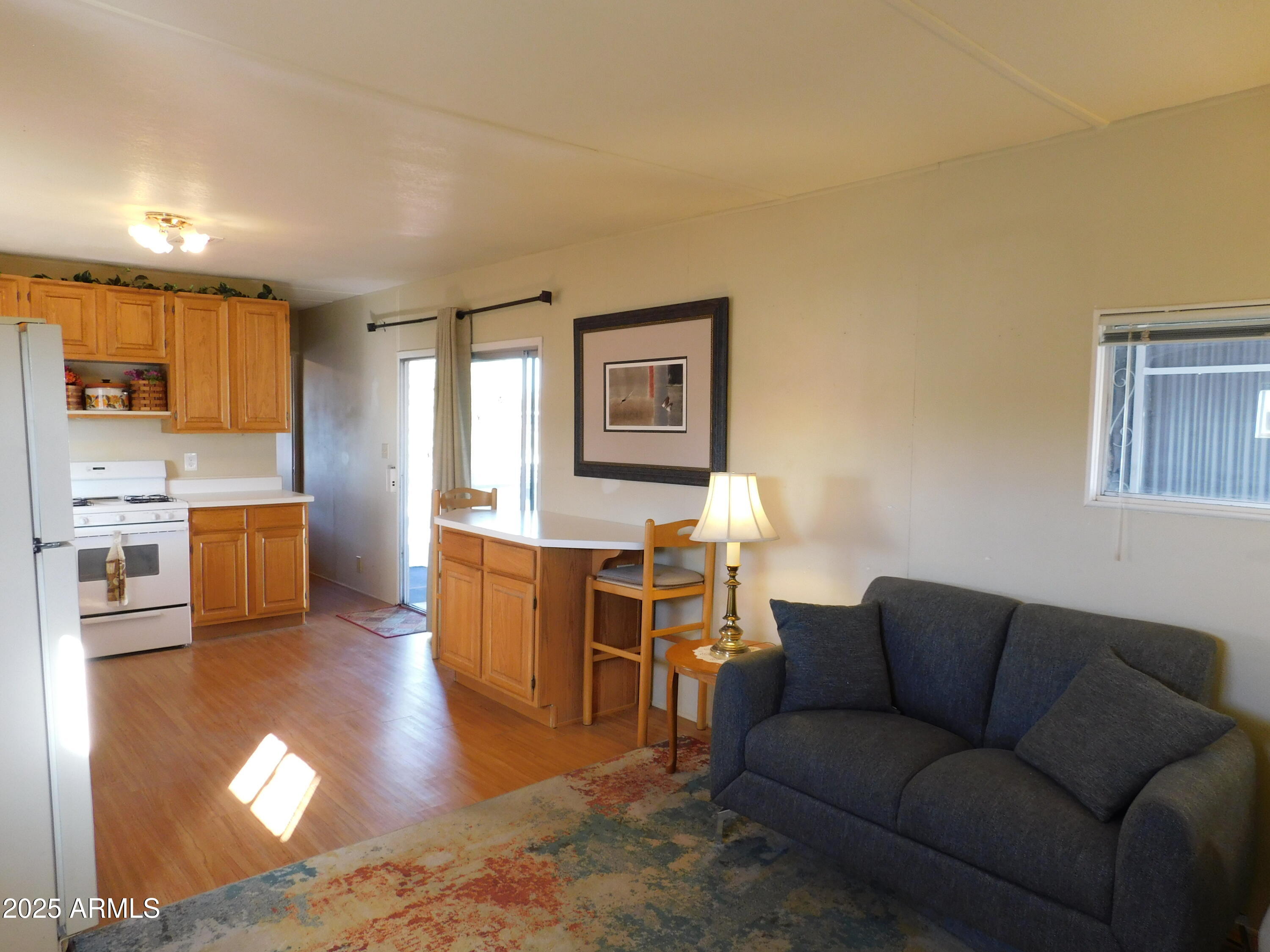 15802 South Gilbert Road, Unit 58 Chandler, AZ 85225 - Photo 8 of 21 a living room with furniture and a kitchen view