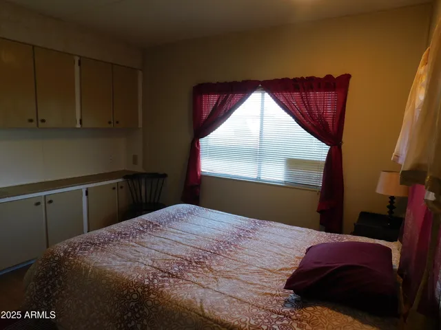 a bathroom with a toilet sink vanity and mirror