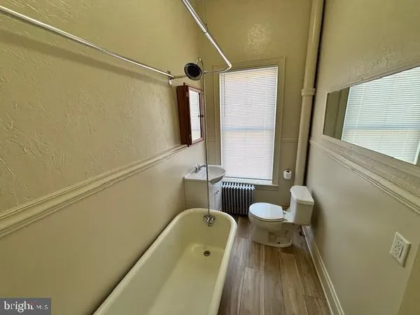 a bathroom with a tub and a sink