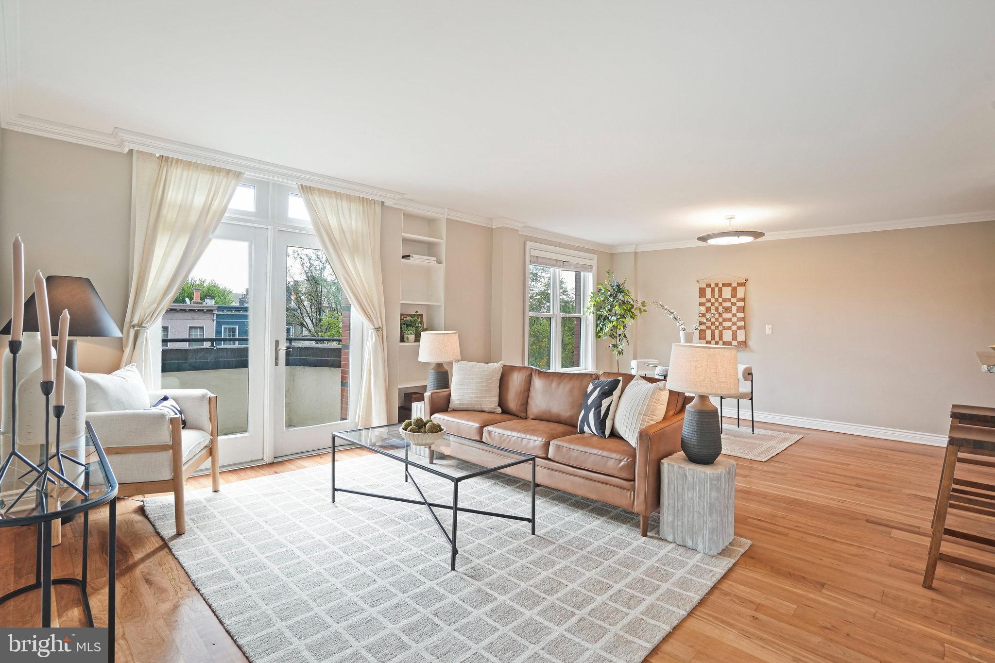 1020 Pennsylvania Ave. Southeast, Unit 404 Washington, DC 20003 - Photo 11 of 24 a living room with furniture and a large window