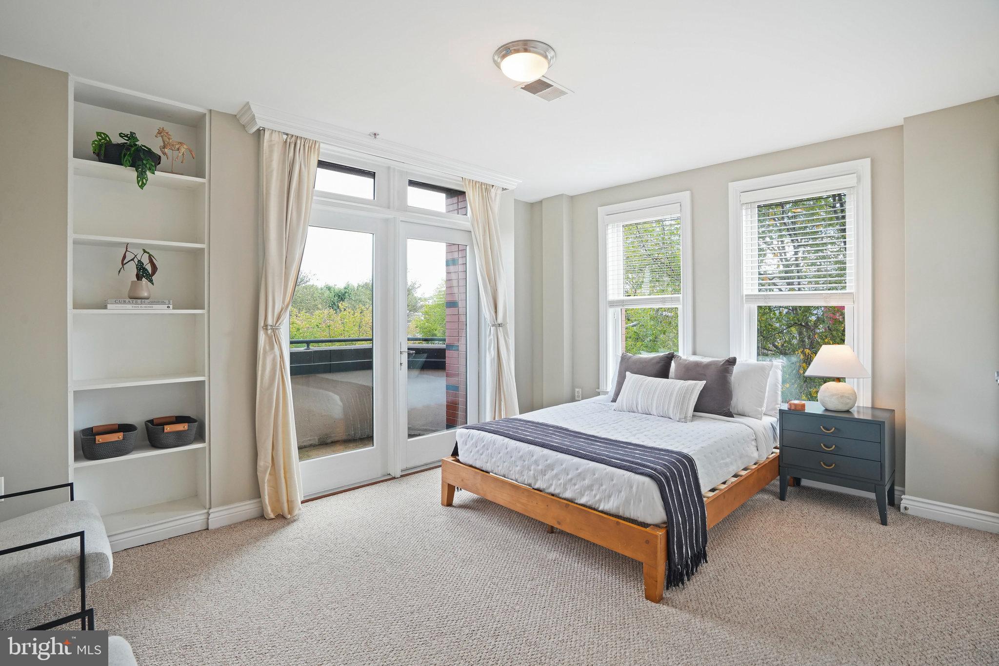 1020 Pennsylvania Ave. Southeast, Unit 404 Washington, DC 20003 - Photo 13 of 24 a bedroom with a bed and large window