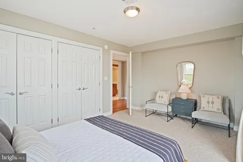 a bedroom with a bed and large window