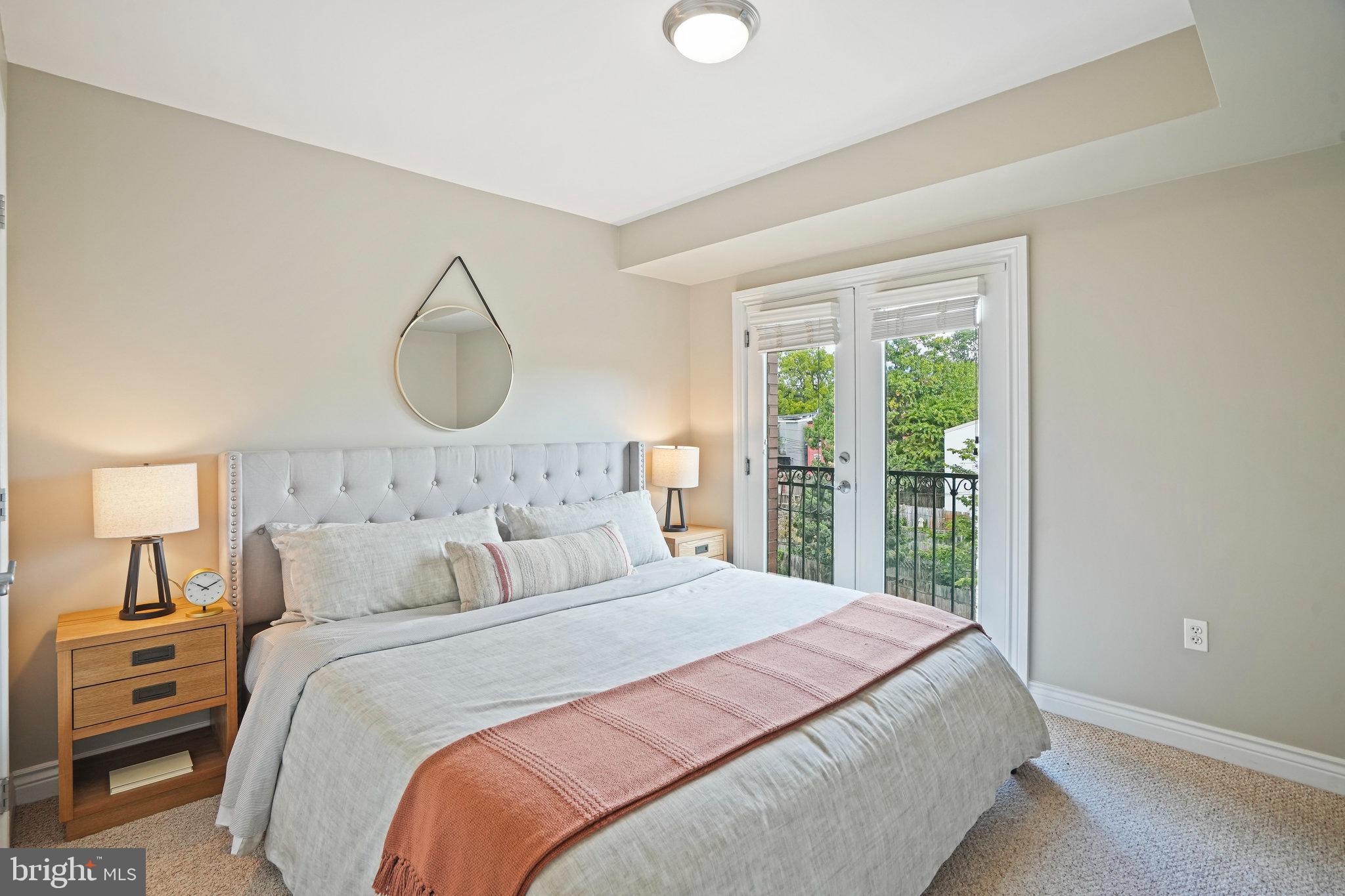 1020 Pennsylvania Ave. Southeast, Unit 404 Washington, DC 20003 - Photo 16 of 24 a bedroom with a large bed and a large window