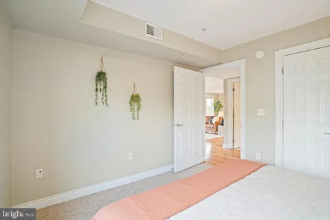 a bedroom with a large bed and a large window