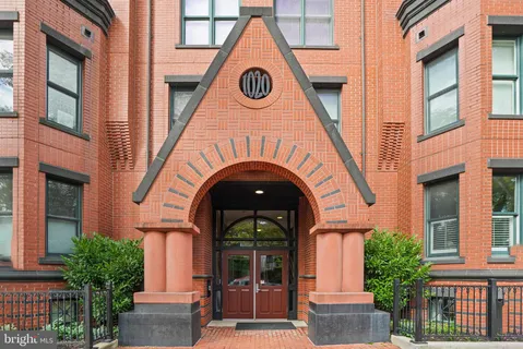 a view of a house with many windows and a tree