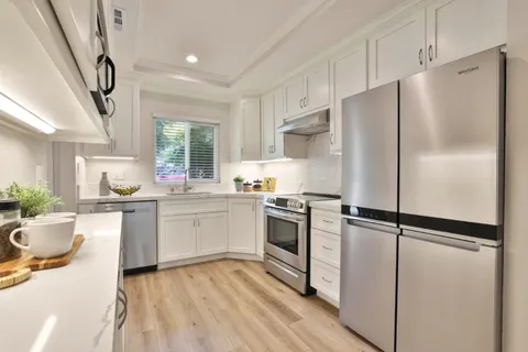 a kitchen with a refrigerator stove and sink