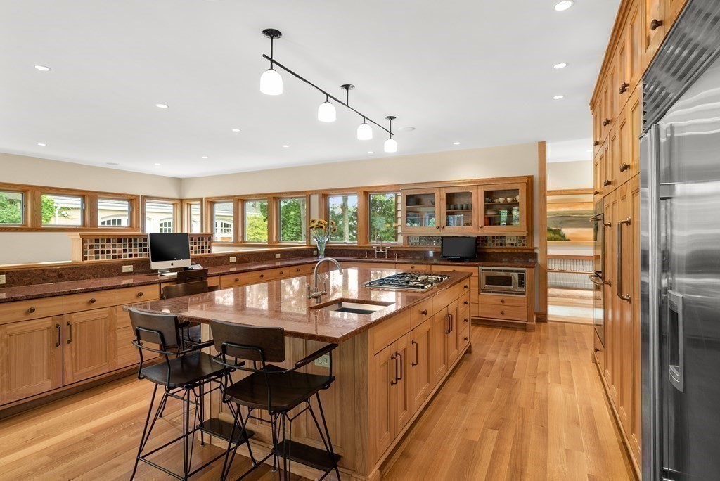 130 Farm Street Dover, MA 02030 - Photo 13 of 39 a kitchen with stainless steel appliances granite countertop counter space and a center island