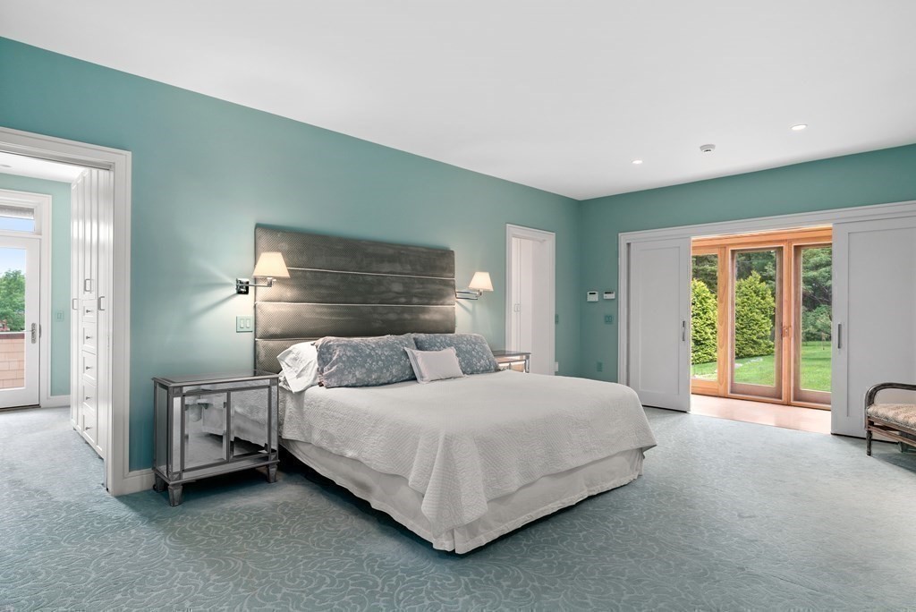 130 Farm Street Dover, MA 02030 - Photo 17 of 39 a bedroom with a bed and a view of en suite bathroom