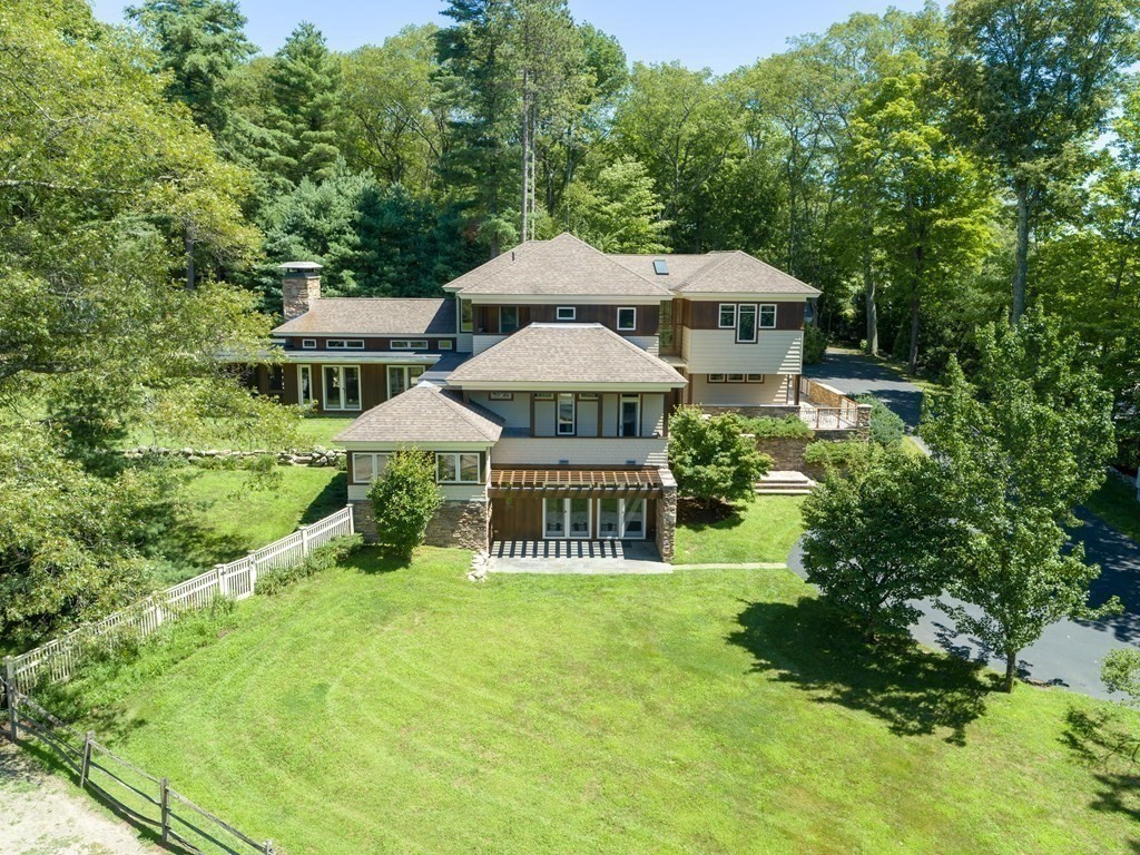 130 Farm Street Dover, MA 02030 - Photo 2 of 39 a view of a chair and table under an umbrella