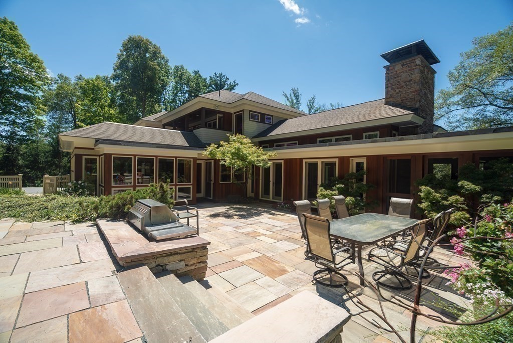 130 Farm Street Dover, MA 02030 - Photo 21 of 39 a view of a house with backyard sitting area and garden