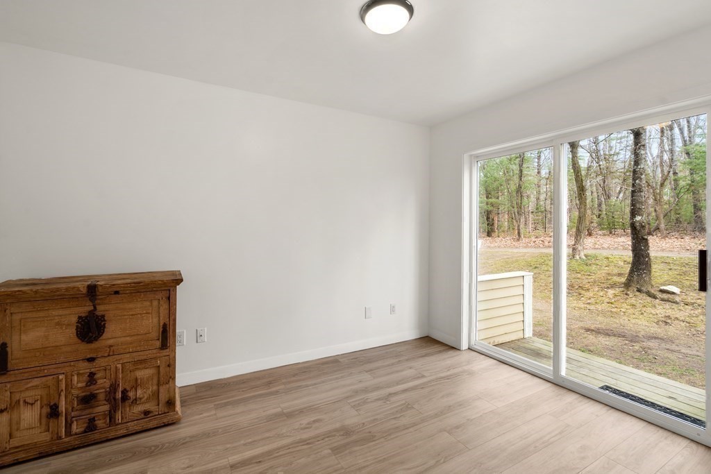 130 Farm Street Dover, MA 02030 - Photo 32 of 39 an empty room with wooden floor and windows