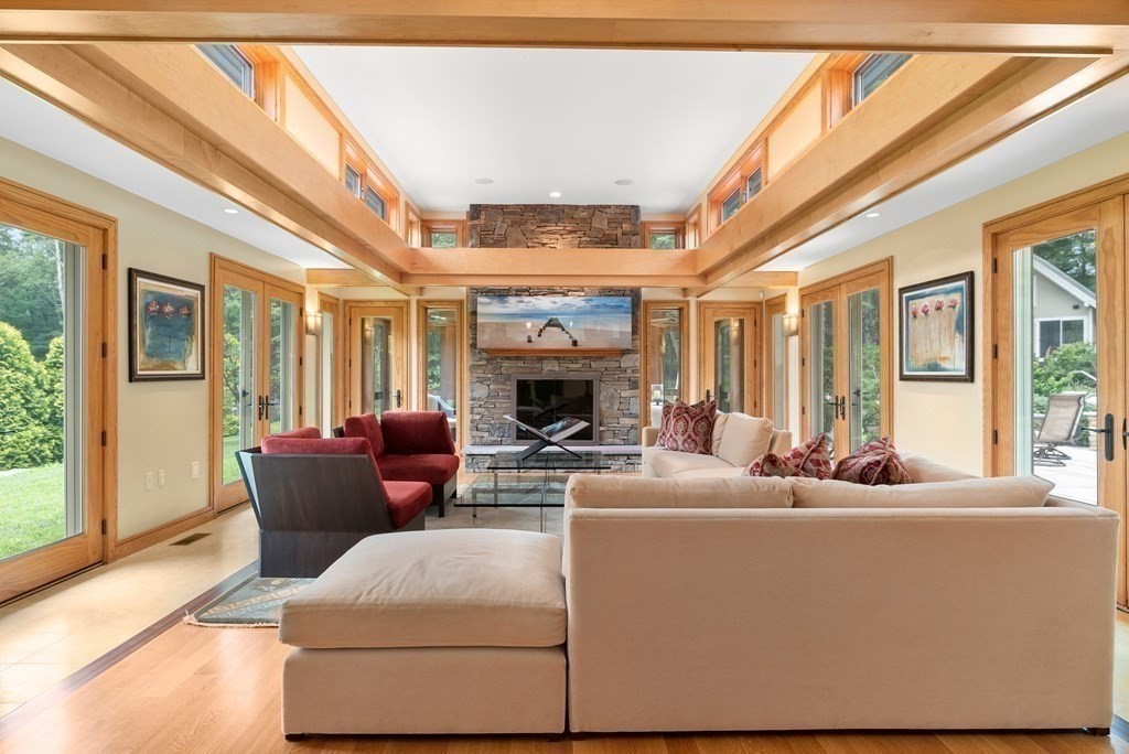 130 Farm Street Dover, MA 02030 - Photo 7 of 39 a living room with furniture a fireplace and a large window