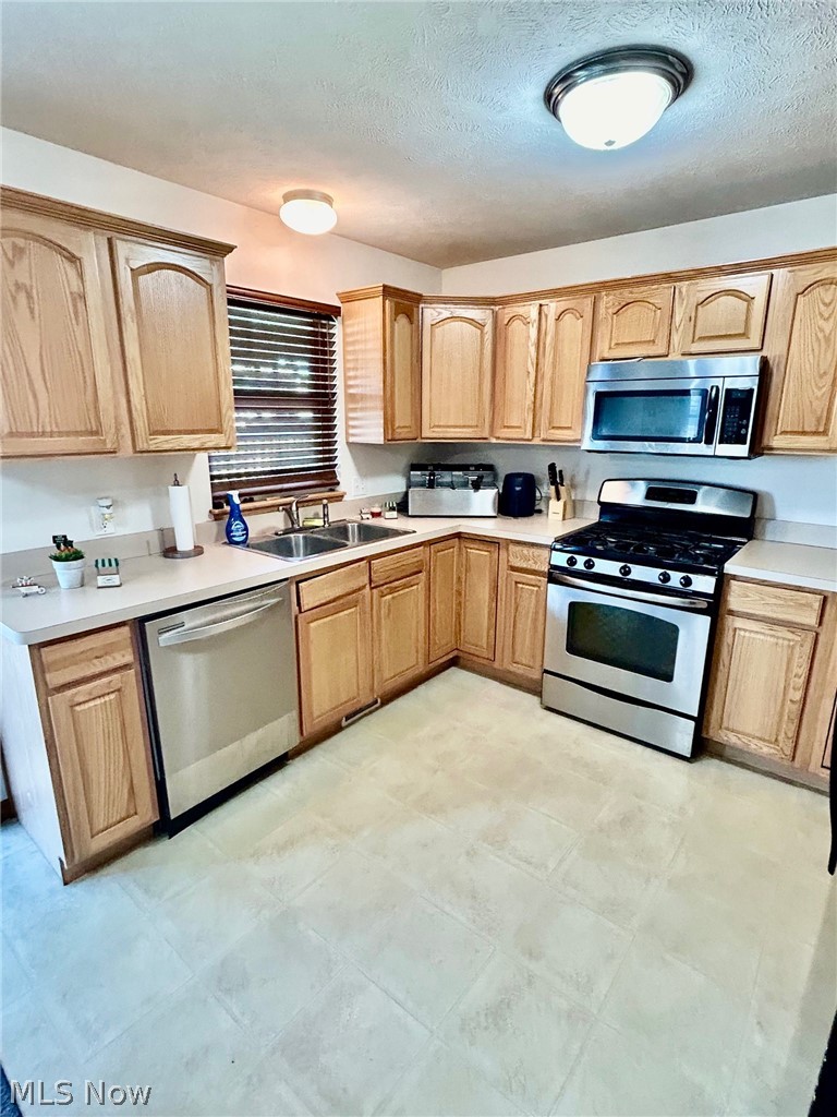30891 Harrison Road Wickliffe, OH 44092 - Photo 2 of 18 Kitchen with light tile floors & stainless steel appliances