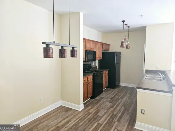 a view of a kitchen with a sink and wooden floor