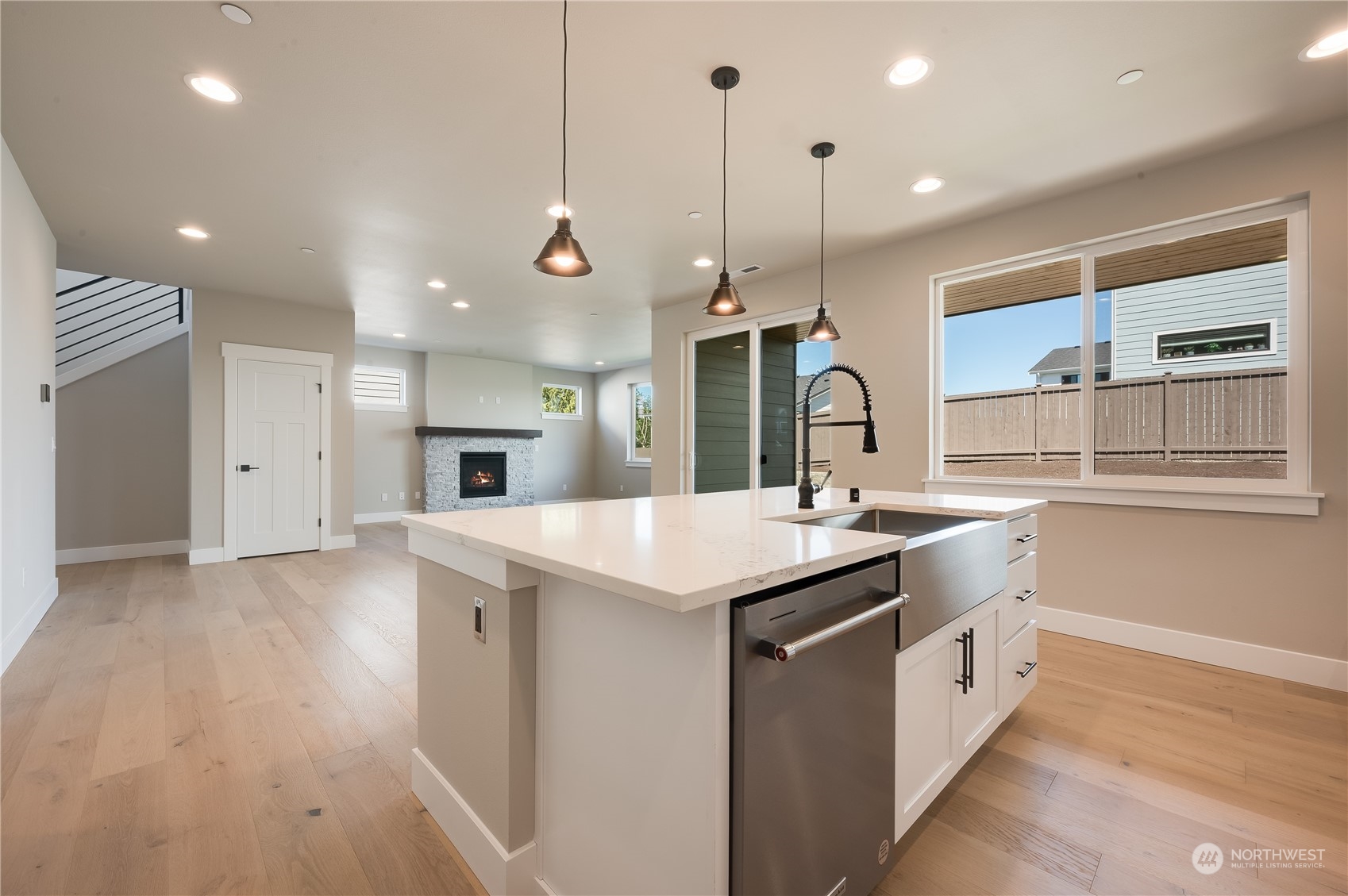 4433 244th Street Southeast, Unit LOT02 Bothell, WA 98021 - Photo 18 of 40 a kitchen with a sink a counter top space stainless steel appliances and a window