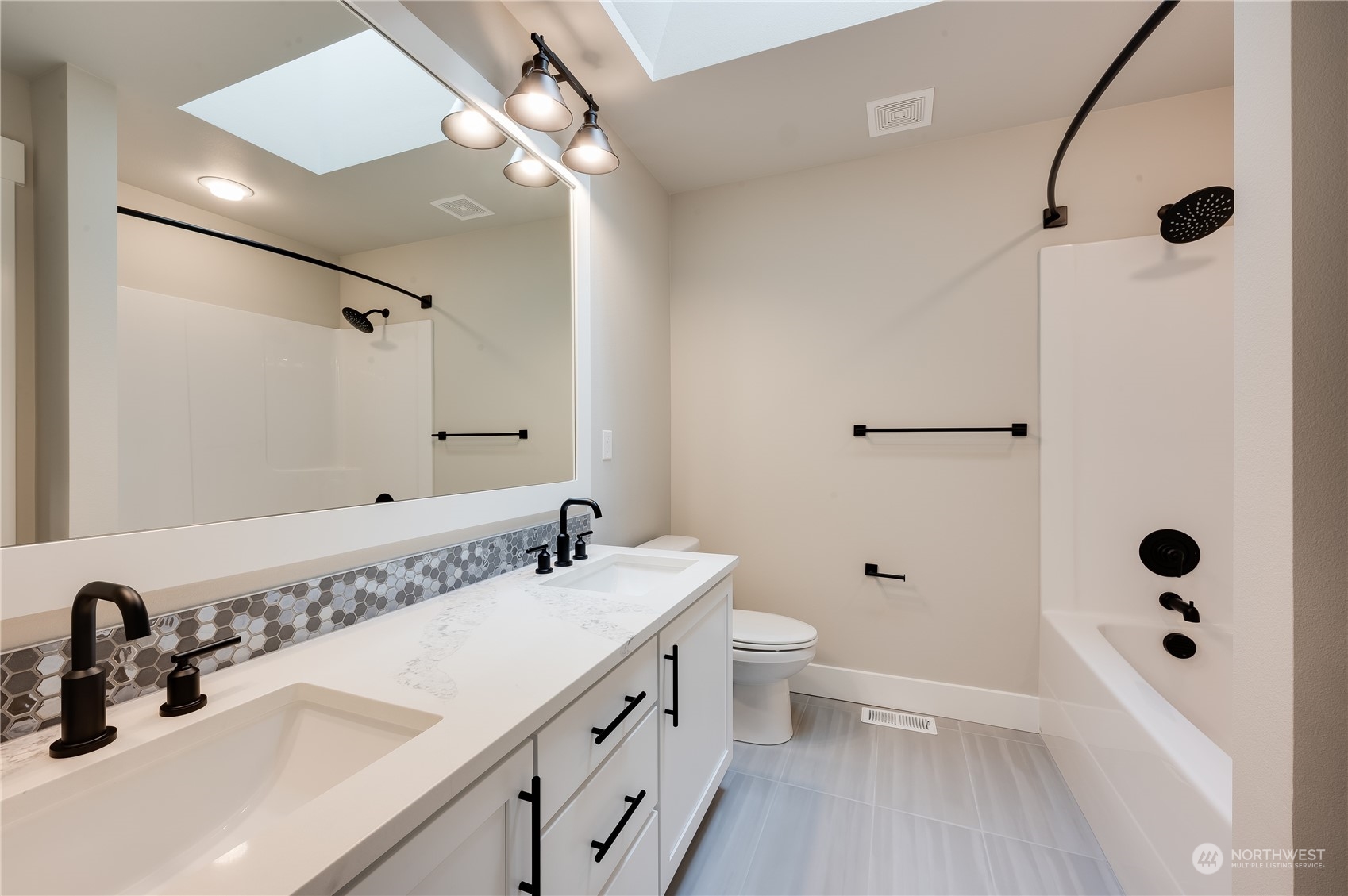 4433 244th Street Southeast, Unit LOT02 Bothell, WA 98021 - Photo 23 of 40 a bathroom with a double vanity sink mirror and toilet