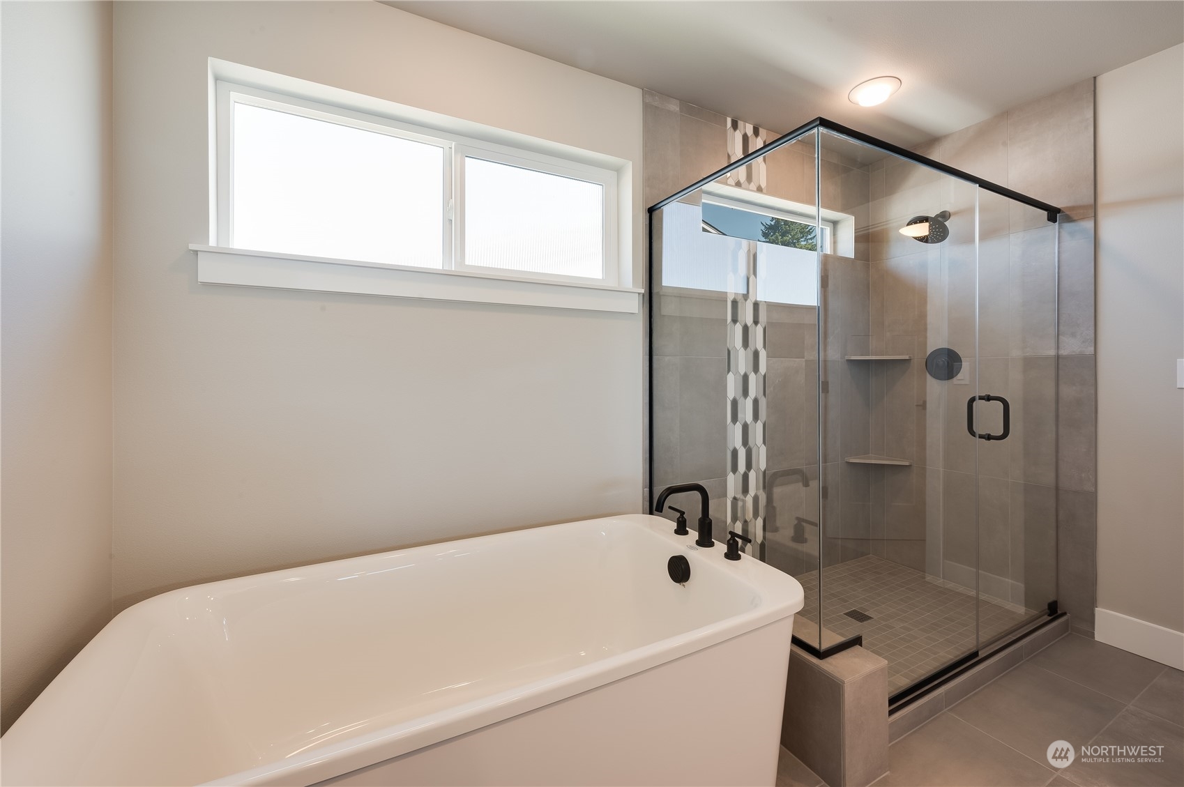 4433 244th Street Southeast, Unit LOT02 Bothell, WA 98021 - Photo 30 of 40 a bathroom with a white bath tub and a shower