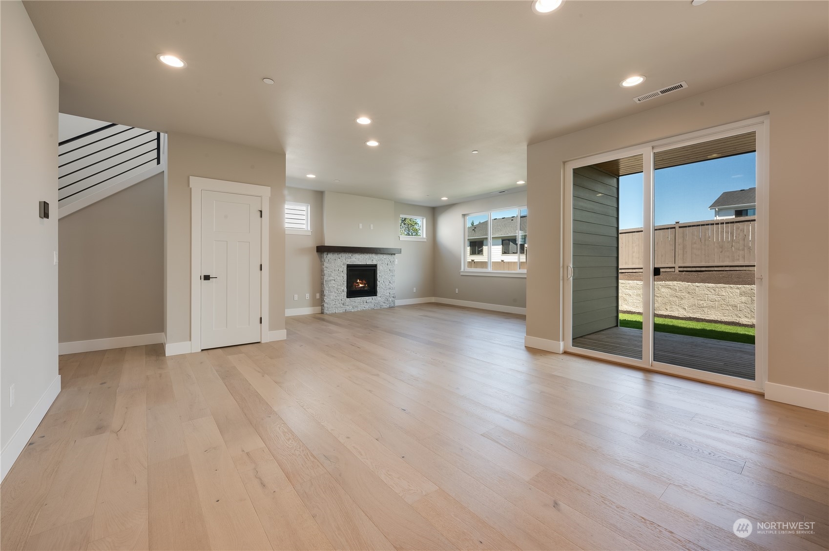 4433 244th Street Southeast, Unit LOT02 Bothell, WA 98021 - Photo 8 of 40 an empty room with wooden floor and entrance to ceiling window
