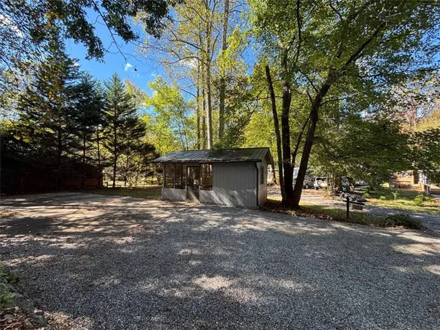 a dirt road with trees in the background