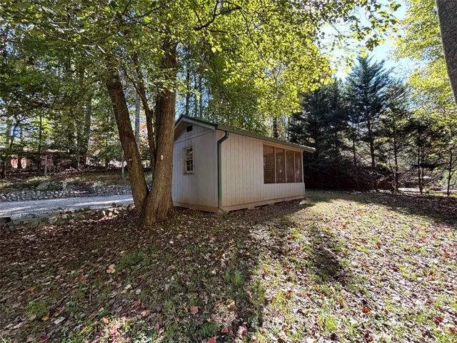 a view of a barn in the middle of a yard