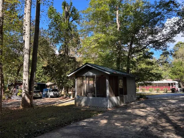 a view of a barn in the middle of a yard