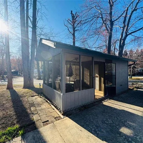 a view of house with backyard and tree