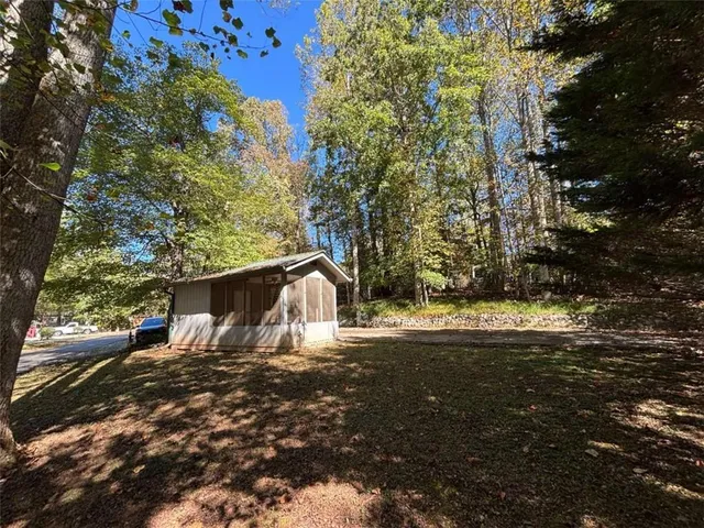 a view of a wooden deck with chairs and a yard
