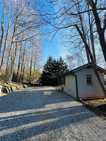 a view of a house with a yard and tree
