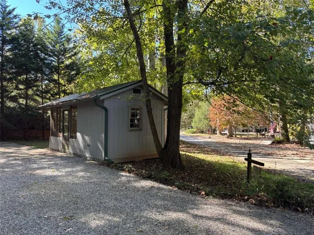 a view of a barn in the middle of a yard