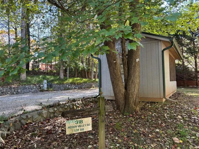 a view of a yard with plants and trees