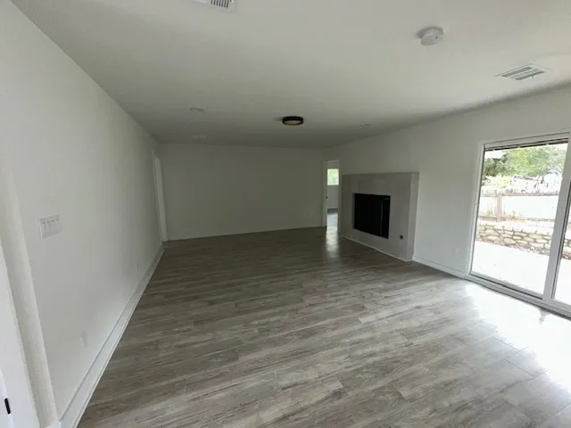 wooden floor in an empty room with a window