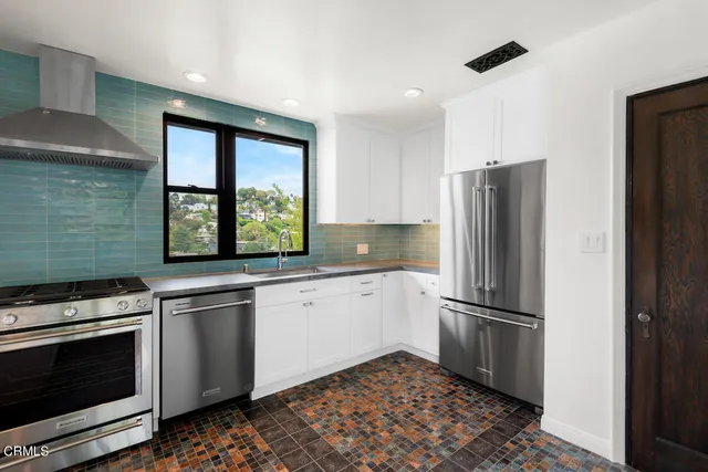 a kitchen with a refrigerator and a sink