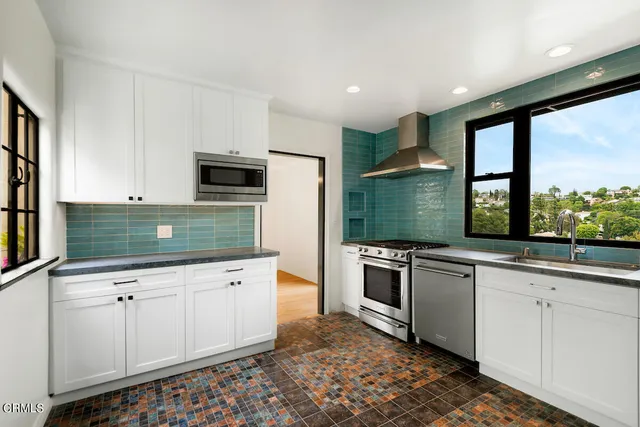 a kitchen with stainless steel appliances granite countertop a stove and a sink
