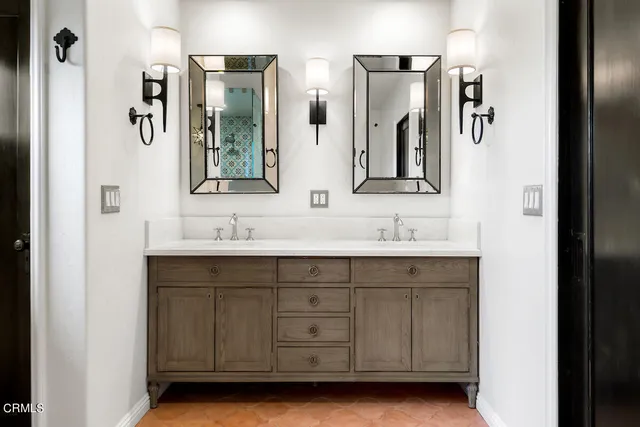 a bathroom with a double vanity sink and mirror