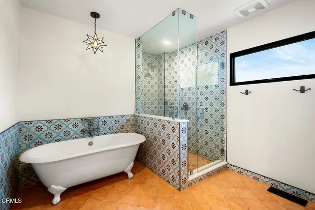 a bathroom with a bathtub and shower