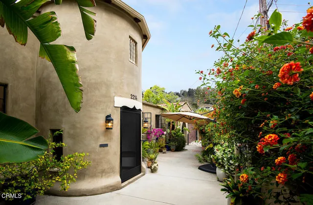 a front view of a house with a yard and flowers