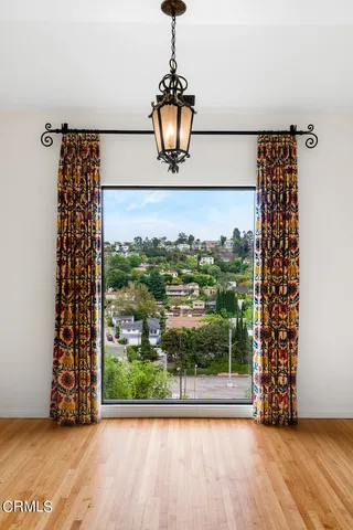 a view of a room with a door and wooden floor