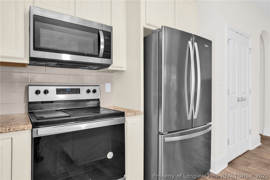 126 Verdmont Drive Raeford, NC 28376 - Photo 14 of 30 a kitchen with cabinets and stainless steel appliances