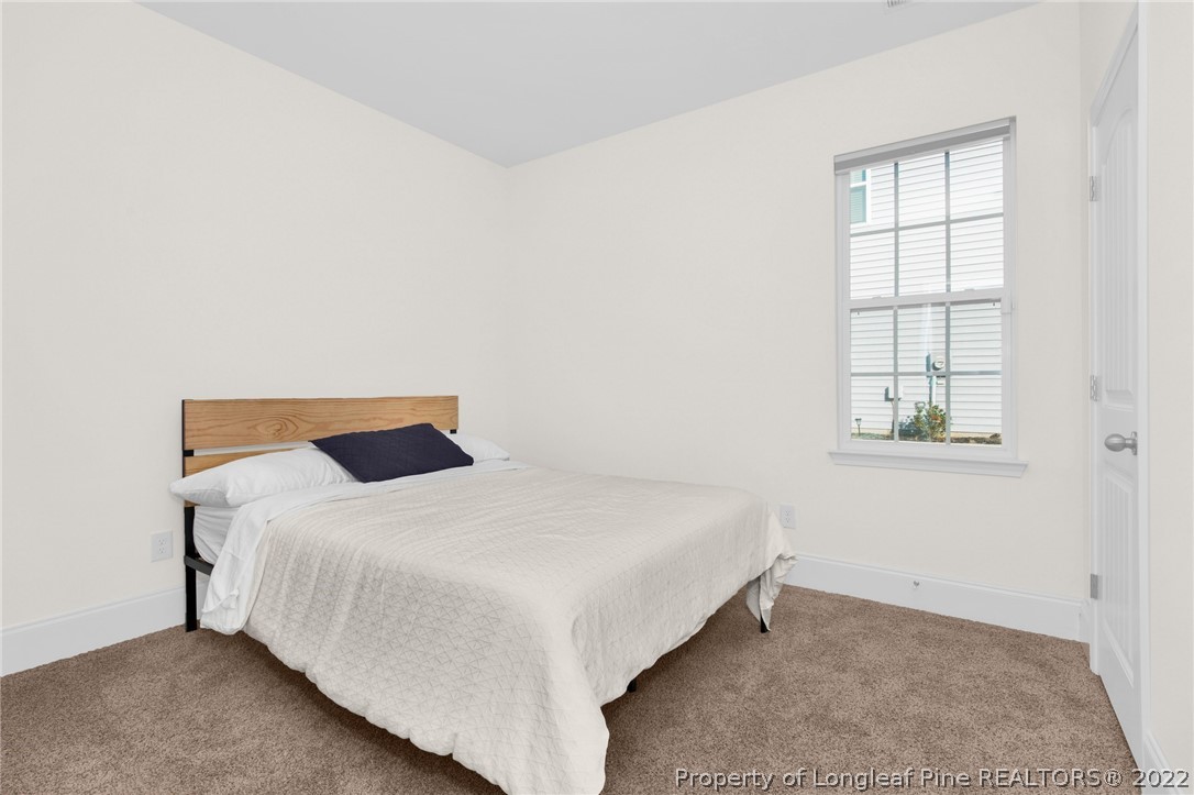 126 Verdmont Drive Raeford, NC 28376 - Photo 17 of 30 a bedroom with a bed and a window