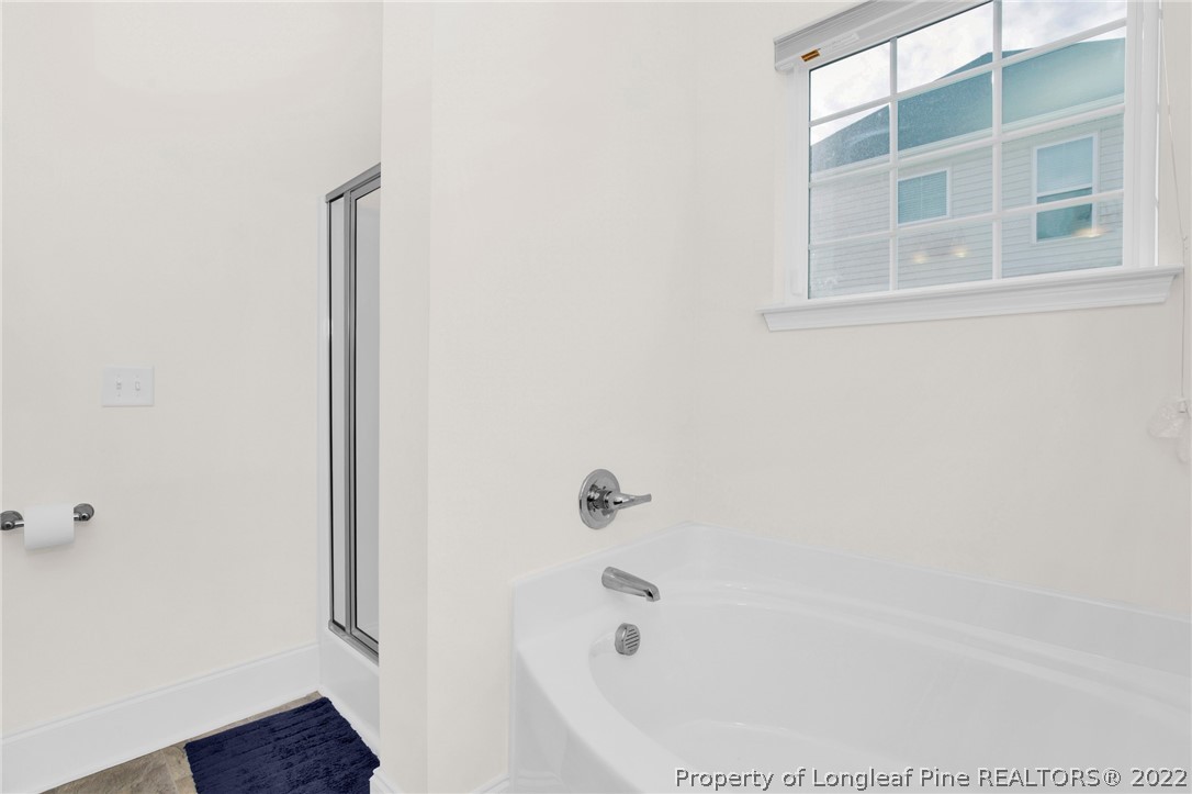 126 Verdmont Drive Raeford, NC 28376 - Photo 24 of 30 a white bath tub sitting next to a shower