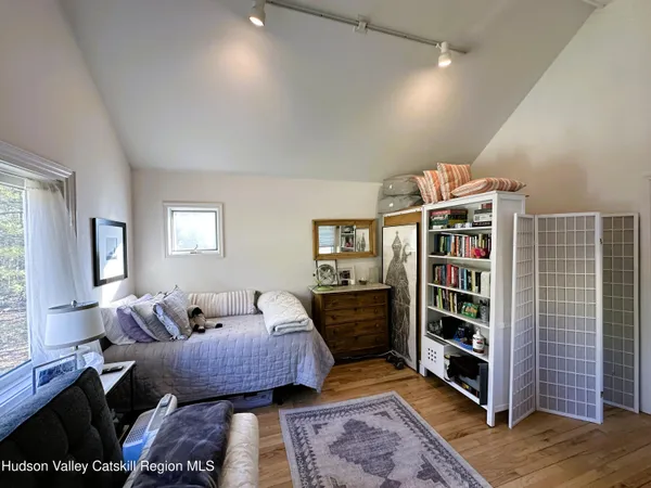 a bedroom with furniture and a rug