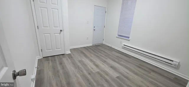 a view of a room with wooden floor