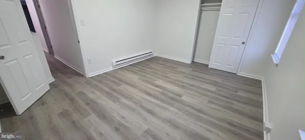 an empty room with wooden floor