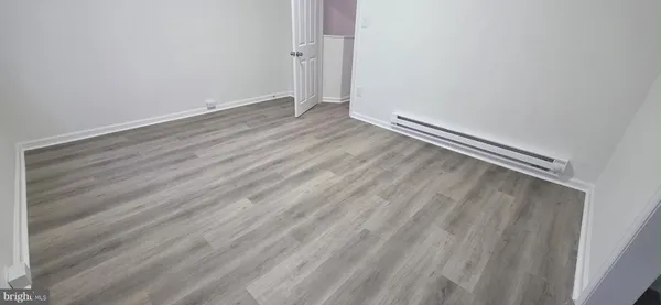 a view of room with wooden floor