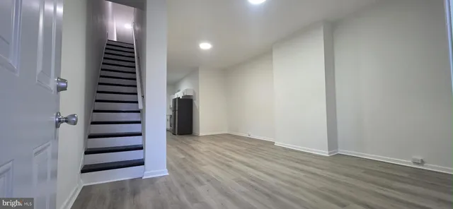 an empty room with wooden floor